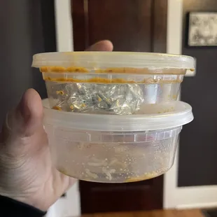 a person holding a container of food