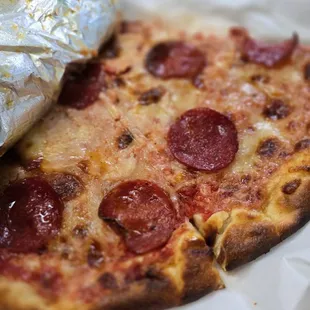 One slice of pepperoni - so big they cut it in half