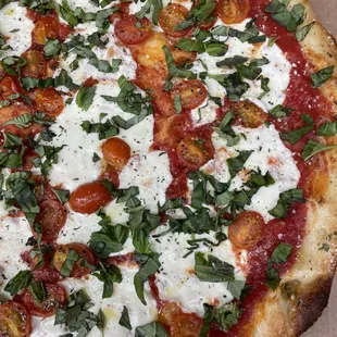 Our Margherita specialty pizza features our housemade red sauce and fresh mozzarella, vine tomatoes, and basil with an EVOO finish.