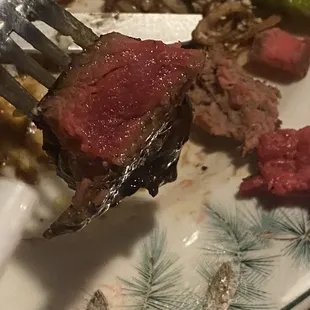 a piece of steak on a plate with asparagus