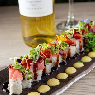 a sushi roll and a glass of wine