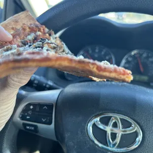 Pizza with two toppings. Notice the side view how flat it is and no sauce.