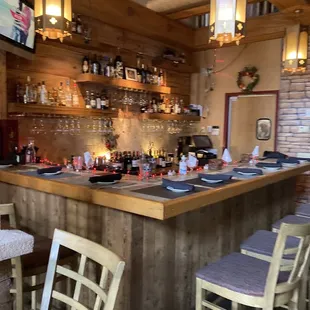 a bar with wine glasses