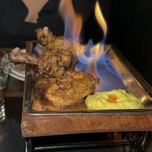 a woman sitting at a table with food on it