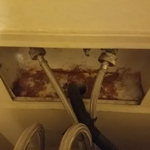 Water line for Washing machine was never fixed, rust and mold were present. A temp fix was put in place, but the job was never completed.