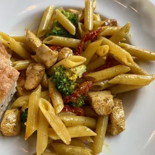 a plate of pasta with chicken and broccoli