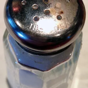 Arrabiata&apos;s salt shaker. It was covered in crud, and I cleaned half of it for comparison.