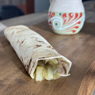 a closeup of a burrito on a cutting board