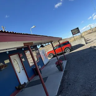 a red car parked in front of the building