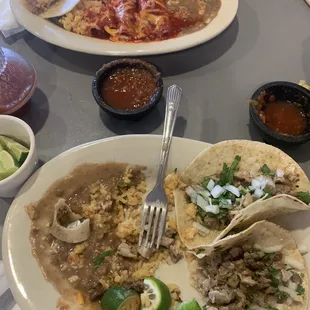 Left more than half plates   Enchiladas salty , tacos and beans   Rice was decent