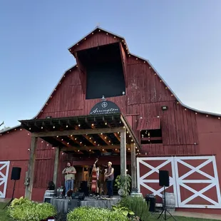 a red barn with a band playing outside