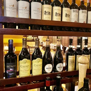 a shelf full of wine bottles