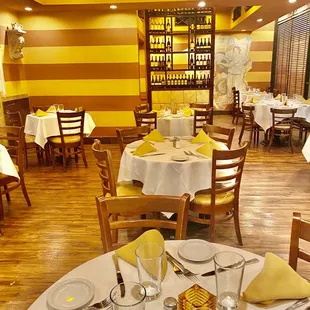 a dining room with yellow and white striped walls