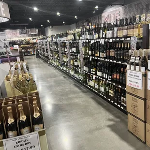 a wide aisle of wine bottles