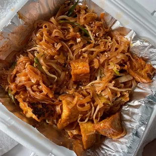 a container of noodles and meat