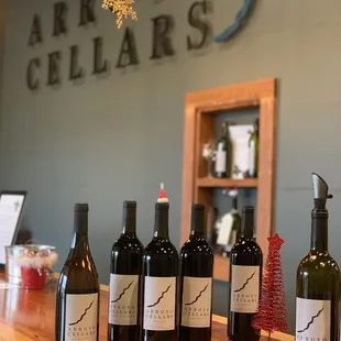 bottles of wine lined up on a bar