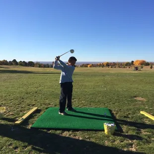 Christopher practicing at the driving range