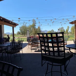 a patio area with tables and chairs