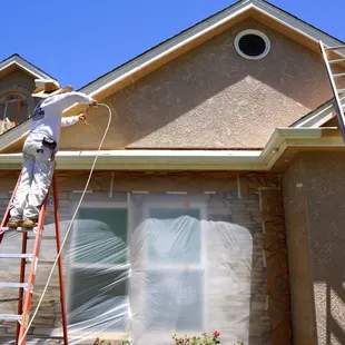 Exterior stucco repaint: One coat primer, two coats of paint &amp; back roll, for best/long lasting finish.
