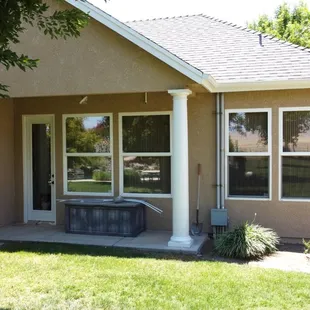 Exterior stucco repaint with white pillars