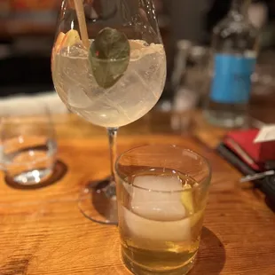 A Proper Gin Tonic: gin, tonic, seasonal accoutrement left and Fall Negroni: calvados, gentian, house vermouth right