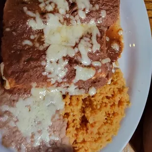 Taco enchilada and burrito with rice and beans
