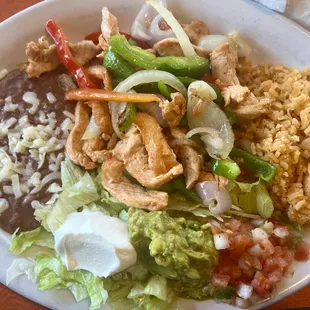 Chicken Fajitas with rice, beans, salsa, sour cream, and guacamole. Your option of corn or flour tortillas
