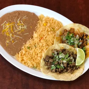 Two corn tortillas tacos with your choice of meat with rice and beans