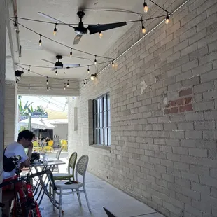 There are tables in this "alleyway" and then more in the back