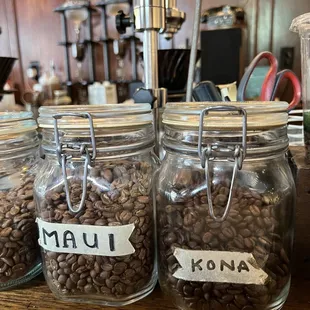 coffee beans in jars with labels on them