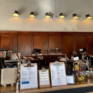 a counter with menus and coffee machines