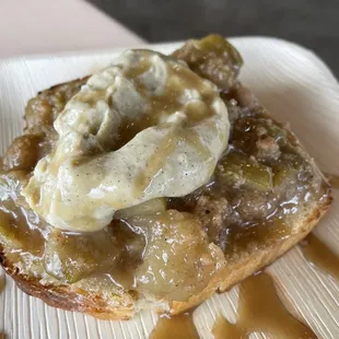 a piece of bread topped with bananas and caramel sauce