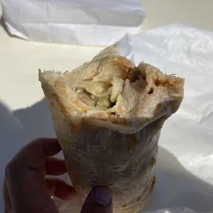 ws a hand holding a burrito