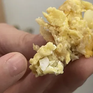 a person holding a piece of food