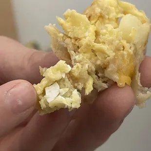 a person holding a piece of food