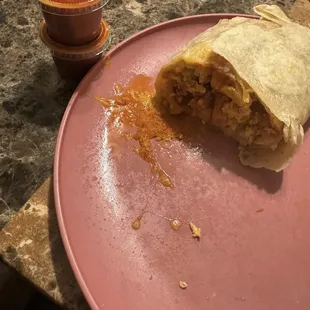 My ham breakfast burrito half with hot sauce included!!