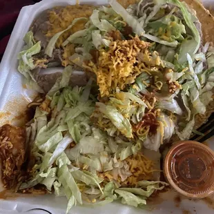 Cheese enchilada, bean tostada, rice, and beans