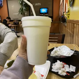 a person holding a drink