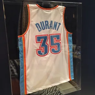 Kevin Durant signed jersey in a 6 sided plexiglass enclosure.