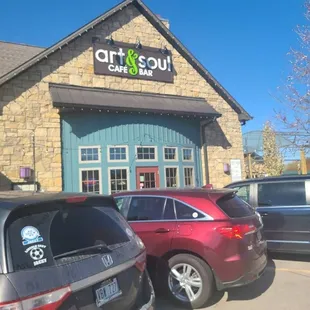 cars parked in front of a cafe