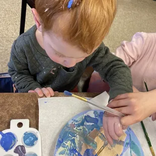 Our littlest painter going all out.