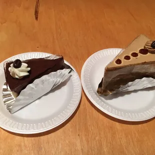 two slices of cake on paper plates