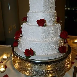 wedding cake with alternating round and hexagonal tiers and scroll designs