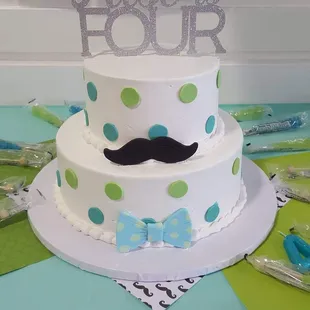 a cake with a mustache on top