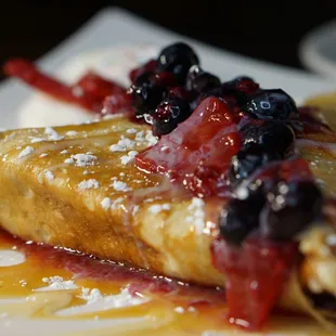 a plate of food with a crepe and ice cream