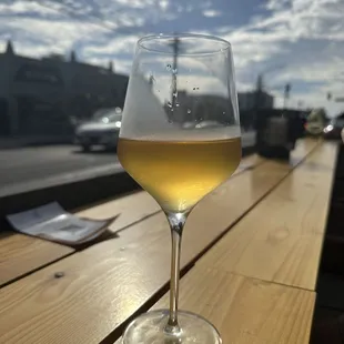 a glass of wine on a wooden table