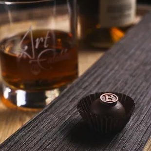a chocolate truffle and a glass of whiskey