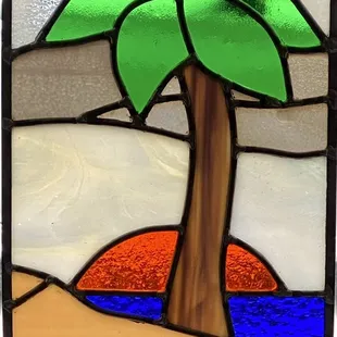 Custom designed and created stained glass- Palm tree in front of an ocean sunset