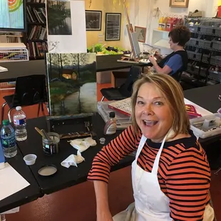 Valorie creates a glowing cabin in her oil landscape she created in oil painting class