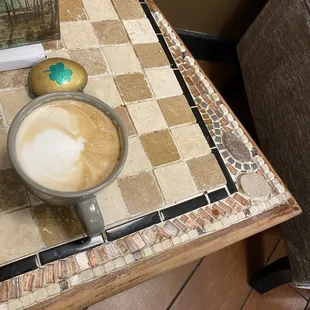 a cup of cappuccino on a table